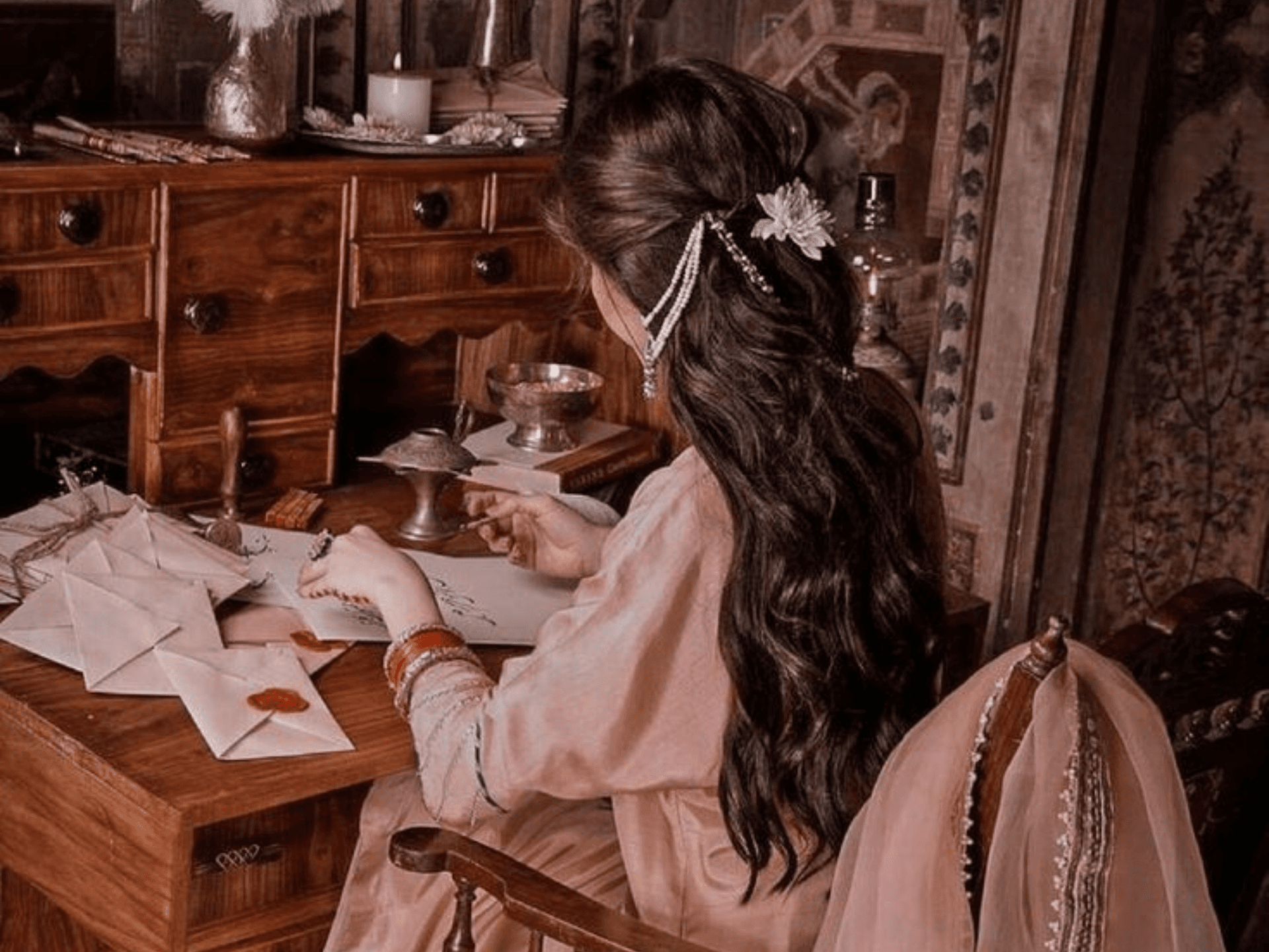 A warm writing desk with Urdu novels, a notebook and a fountain pen