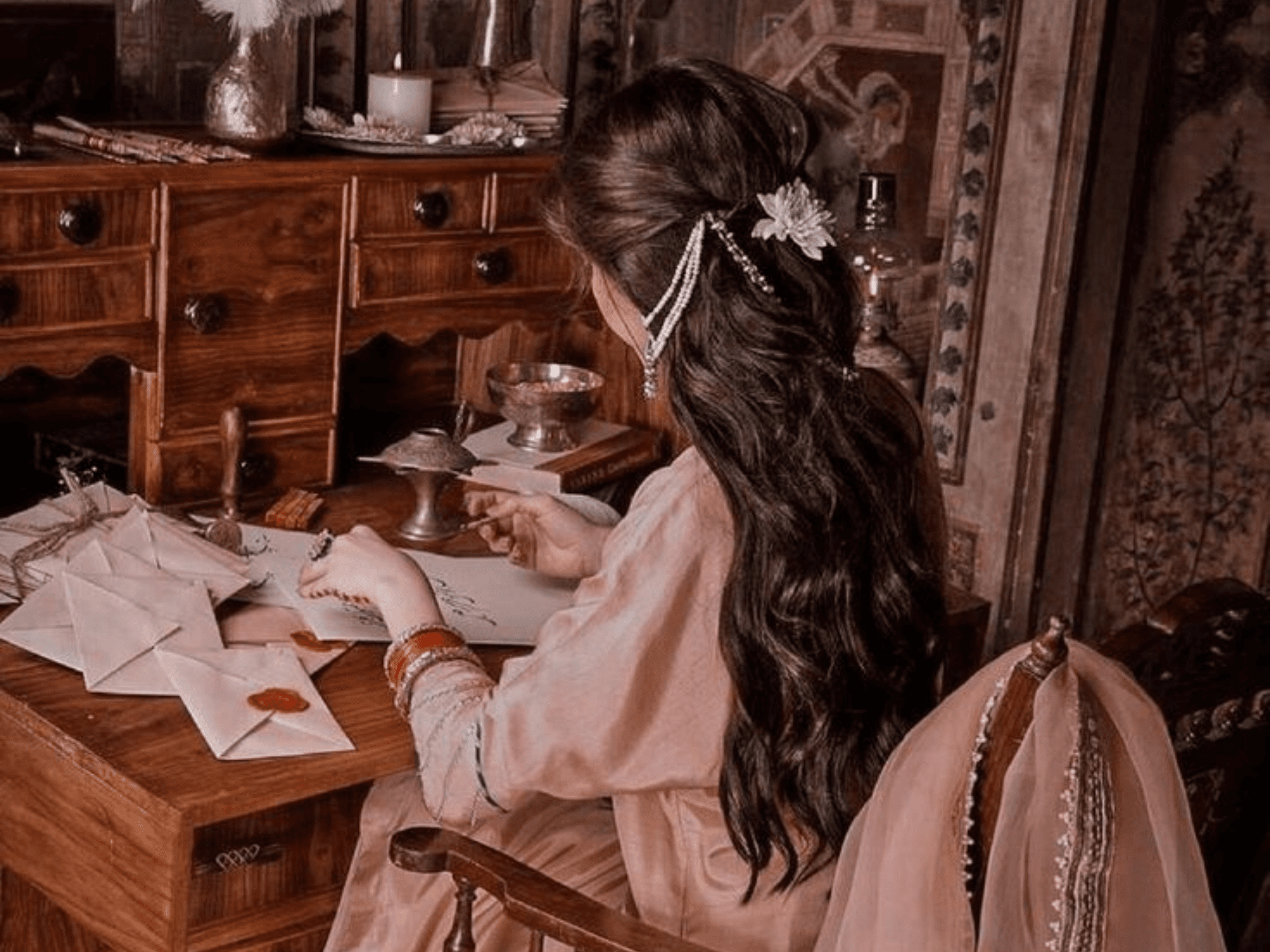 Reading desk with Urdu novels, a notebook and warm light